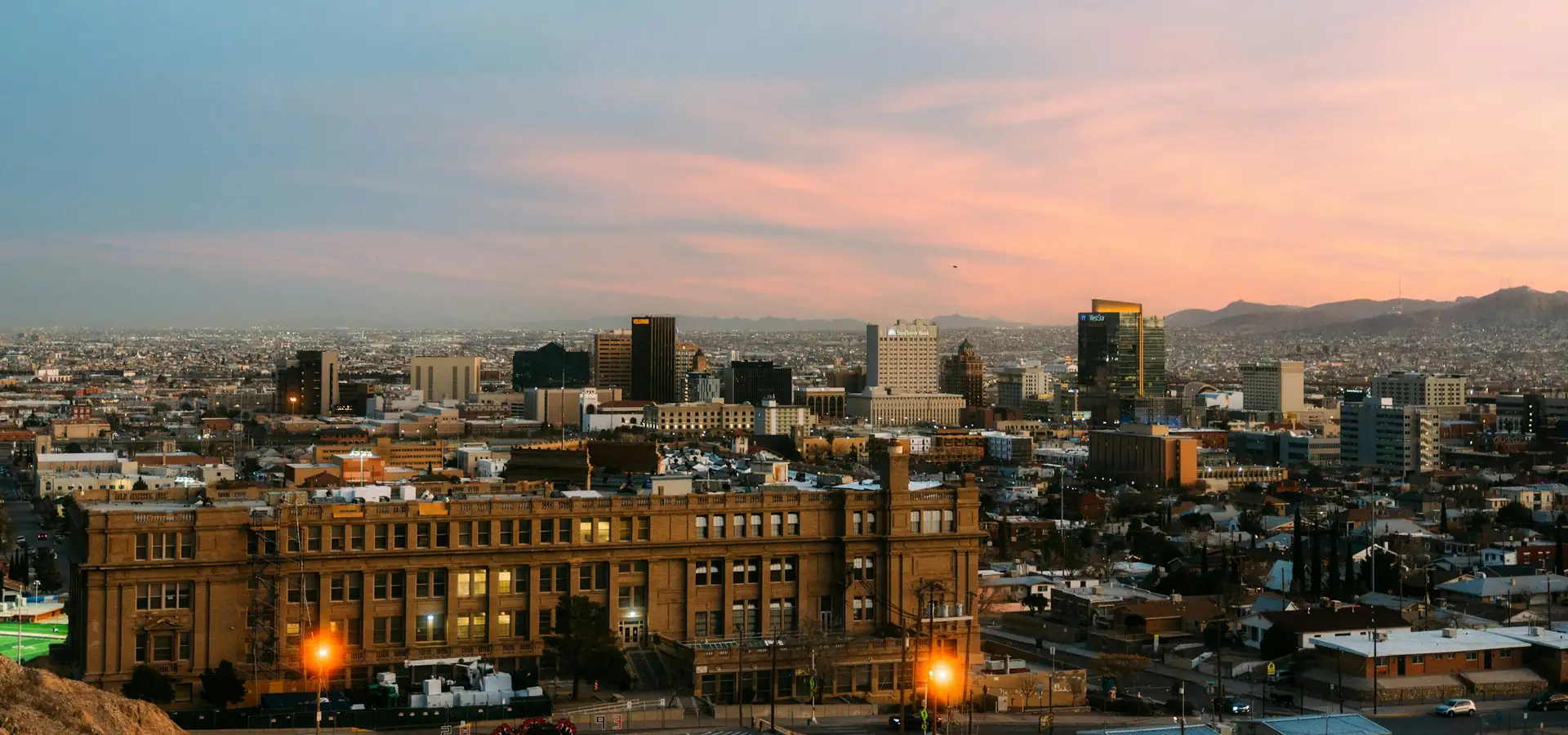 Downtown El Paso, Texas skyline at dusk with mountains on the horizon