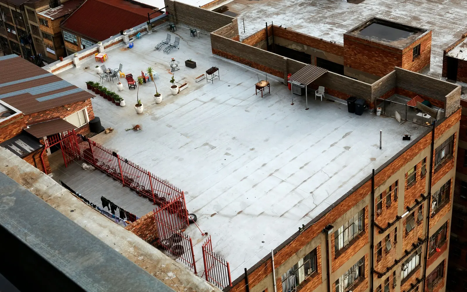 Aerial view of a white coated flat roof on a brick building